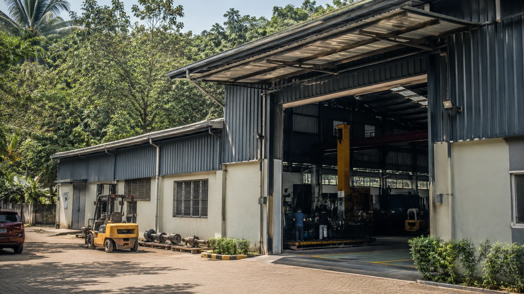 AR Hydraulics and Sealing Solutions workshop exterior with an open bay door, forklift and parked vehicles, surrounded by palm trees
